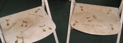 Old folding chairs updated with broadway musical titles- Musical Chairs by Ellen Leigh