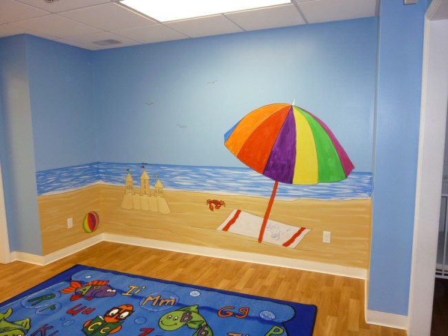 Outdoor cartoon murals in a day care center beach theme