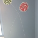 Stylized graphics of bouncing balls to coordinate with boy's bedding. Mural by Ellen Leigh