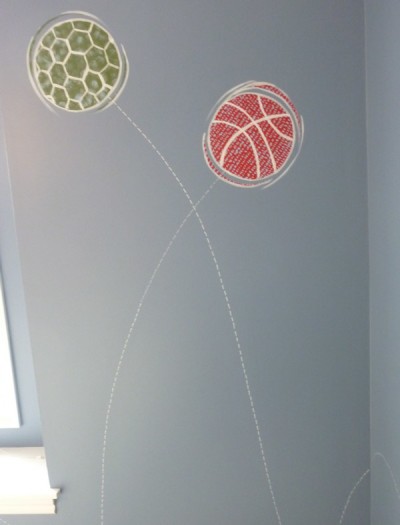 Stylized graphics of bouncing balls to coordinate with boy's bedding. Mural by Ellen Leigh