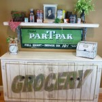 Distressed cabinet gets a new lighter finish and personality with signage by Ellen Leigh