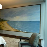 Peaceful Beach covers nearly a full wall in a master bedroom. Frame is painted on the wall to match the wood floor. Mural by Ellen Leigh