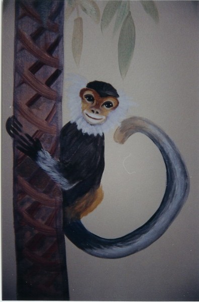 In a jungle themed room, this monkey smiles out as he climbs a banana tree. Mural by Ellen Leigh
