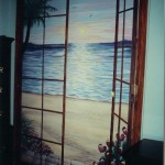 Hawaiian Doors Bypass closet doors painted with a view of the beach at sunset, footprints in the sand. Mural by Ellen Leigh