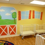 Cartoonish windows and farm scene in baby nursery in the day care. Mural by Ellen Leigh
