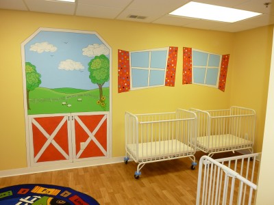 Cartoonish windows and farm scene in baby nursery in the day care. Mural by Ellen Leigh